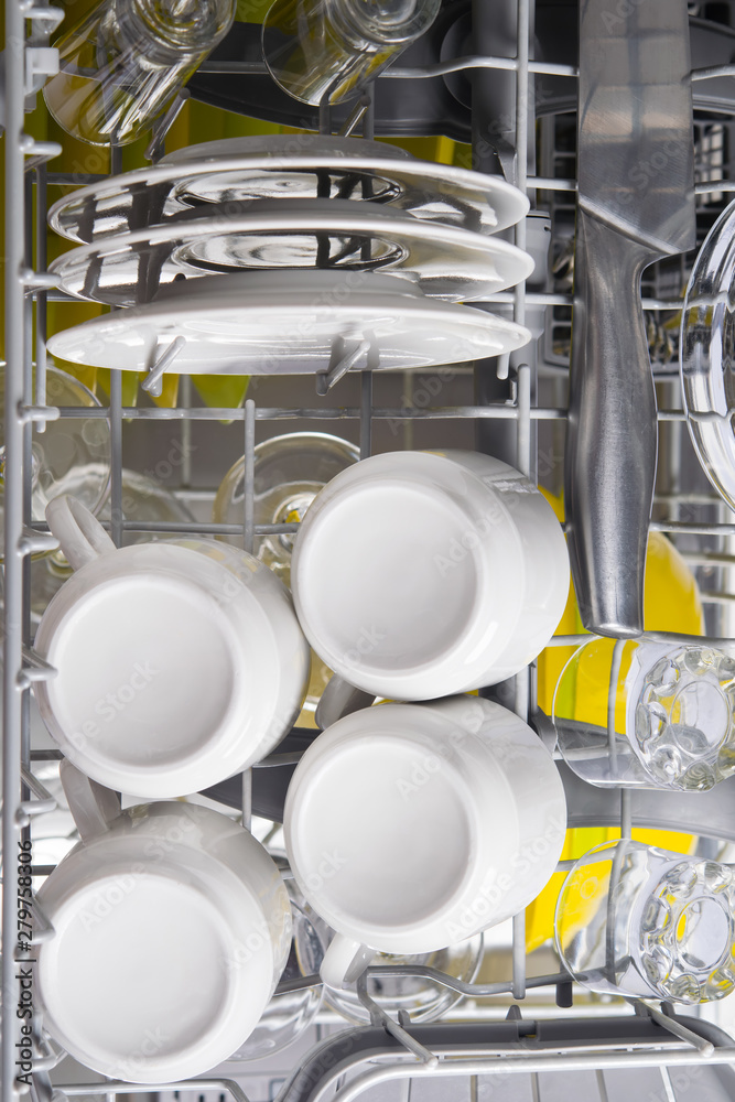 top view, in the dishwasher, clean dishes, mugs, plates and metal appliances top view, in the dishwasher, clean dishes, mugs, plates and metal appliances