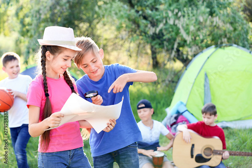 Little children with map re...