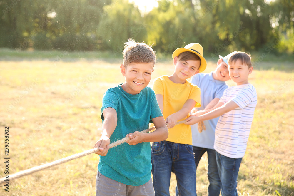 Fototapeta premium Group of children pulling rope at summer camp