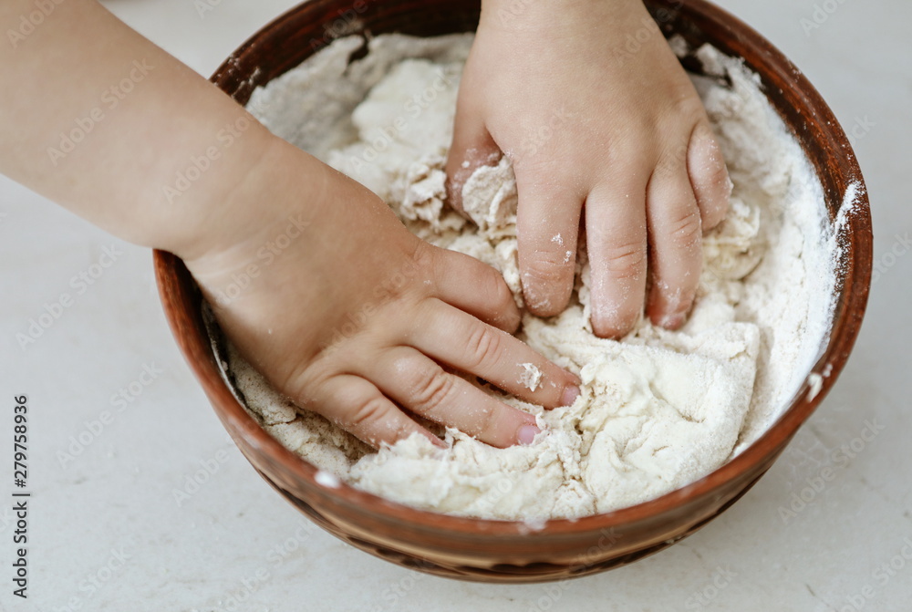 baby hands knead the dough in a pizza plate baby hands knead the dough in a pizza plate