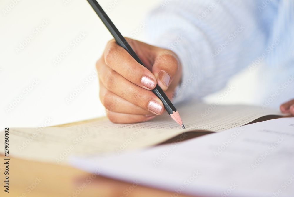take the exam final high school university student holding pencil writing on paper answer sheet - education college in class taking notes sitting learning writing selected choice in examination room take the exam final high school university student holding pencil writing on paper answer sheet - education college in class taking notes sitting learning writing selected choice in examination room