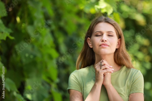 Religious woman praying to ...