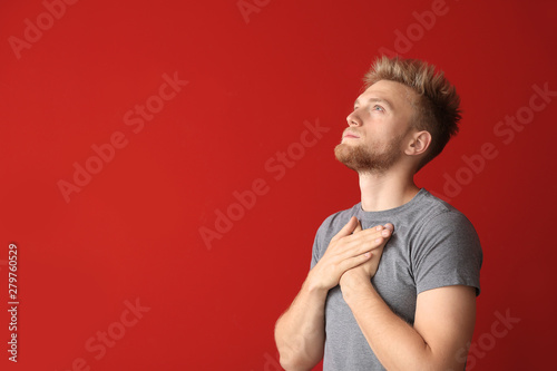 Religious young man praying...