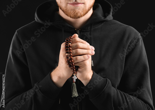 Religious young man praying...