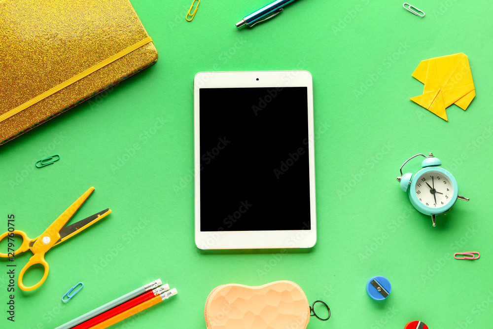 Tablet computer and school supplies on color background Tablet computer and school supplies on color background