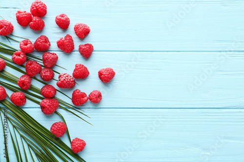 Many ripe raspberry on wooden background