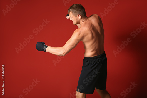 Strong male boxer on color background © Pixel-Shot