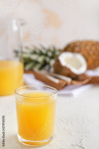 Glass of fresh pineapple juice on light table
