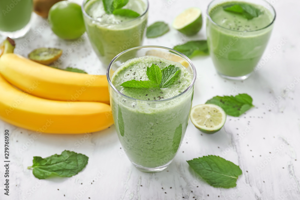 Glasses of healthy fruit smoothie on table Glasses of healthy fruit smoothie on table