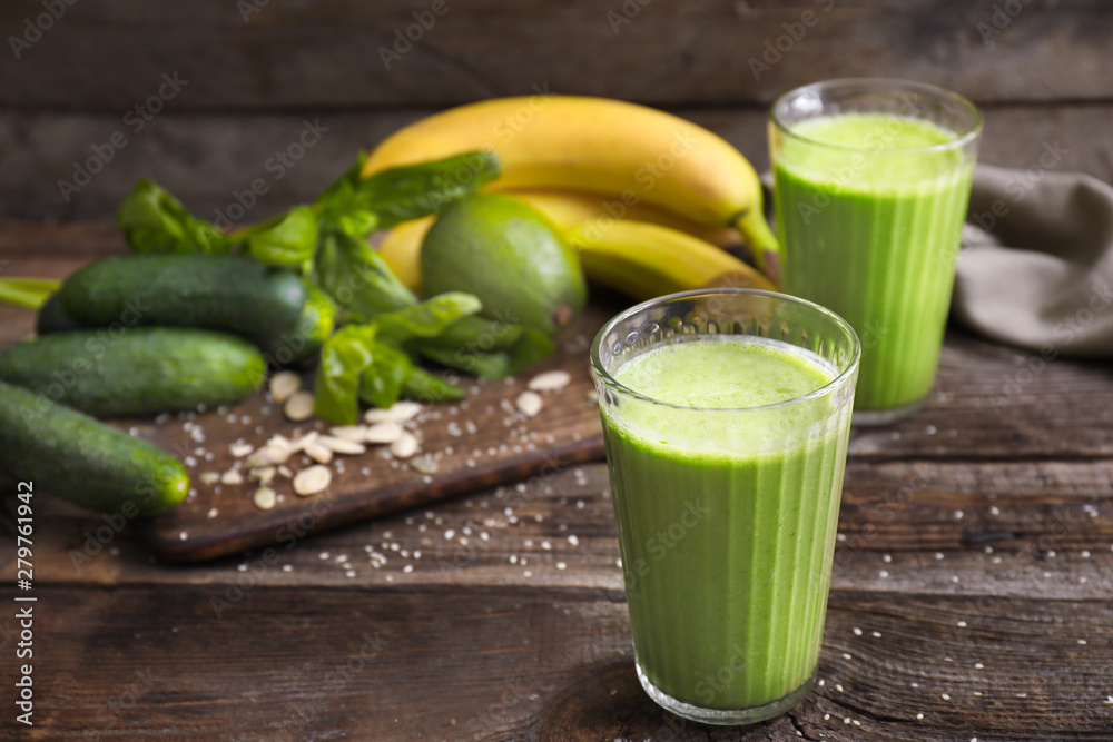 Glasses of healthy smoothie on wooden table Glasses of healthy smoothie on wooden table