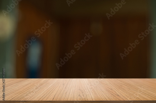 Empty wooden tabletop with blur montage restaurant background.