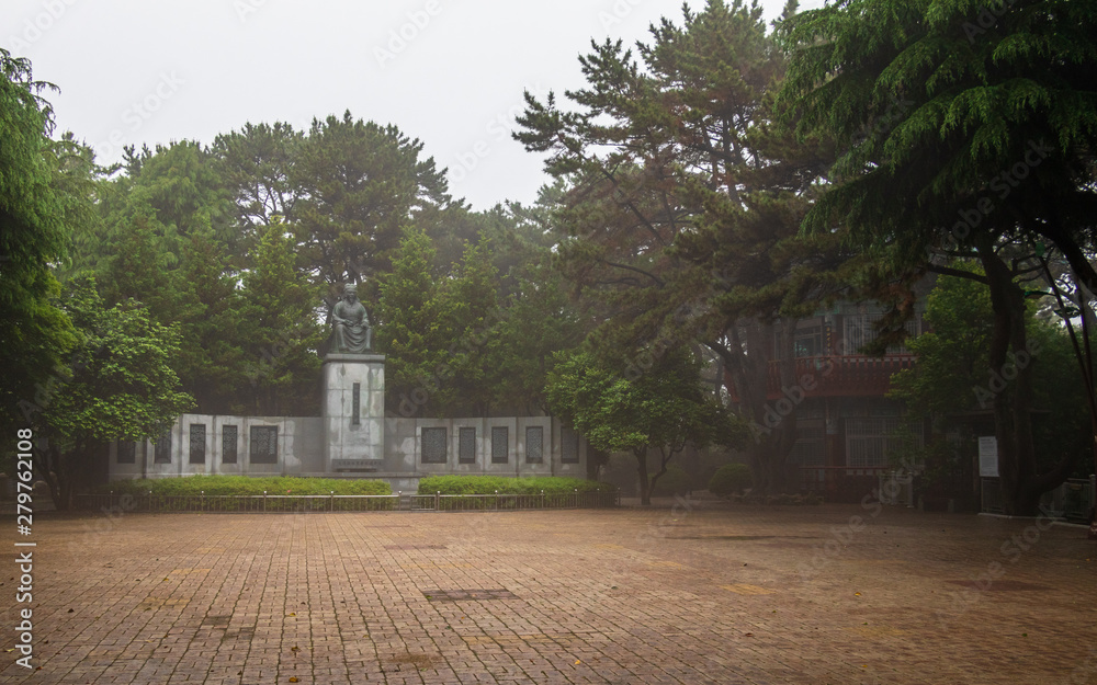 Central Square with Statue of Choe Chiwon and Pavilion in Dongbaek Park on a foggy day. Haeundae-gu, Busan, South Korea. Asia.