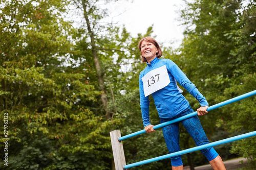 Senior woman exercises on the gym equipment