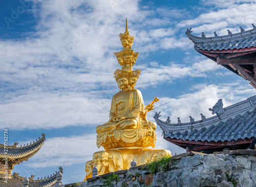 Ten-way Puxian gold statue at the top of Emei Mountain in Sichuan Province, China photo