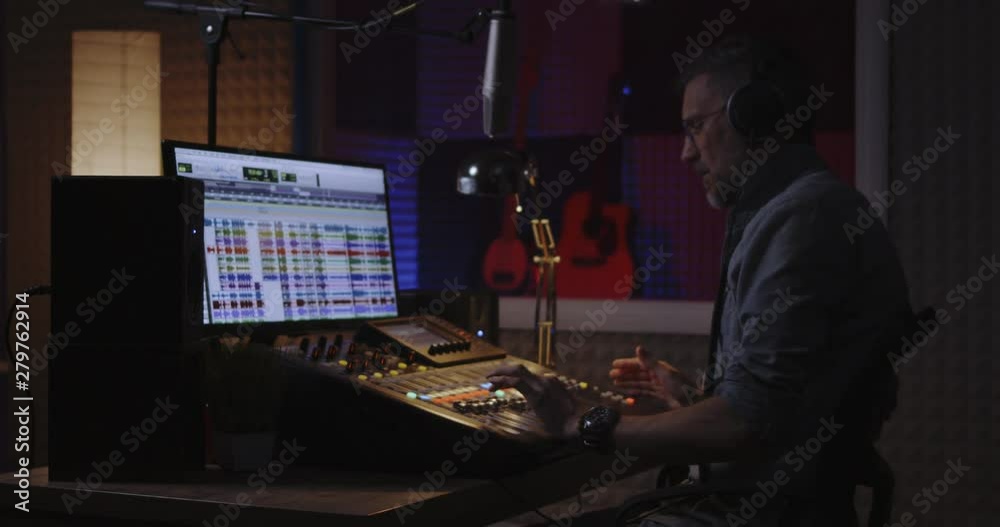 Man recording his own voice part in studio