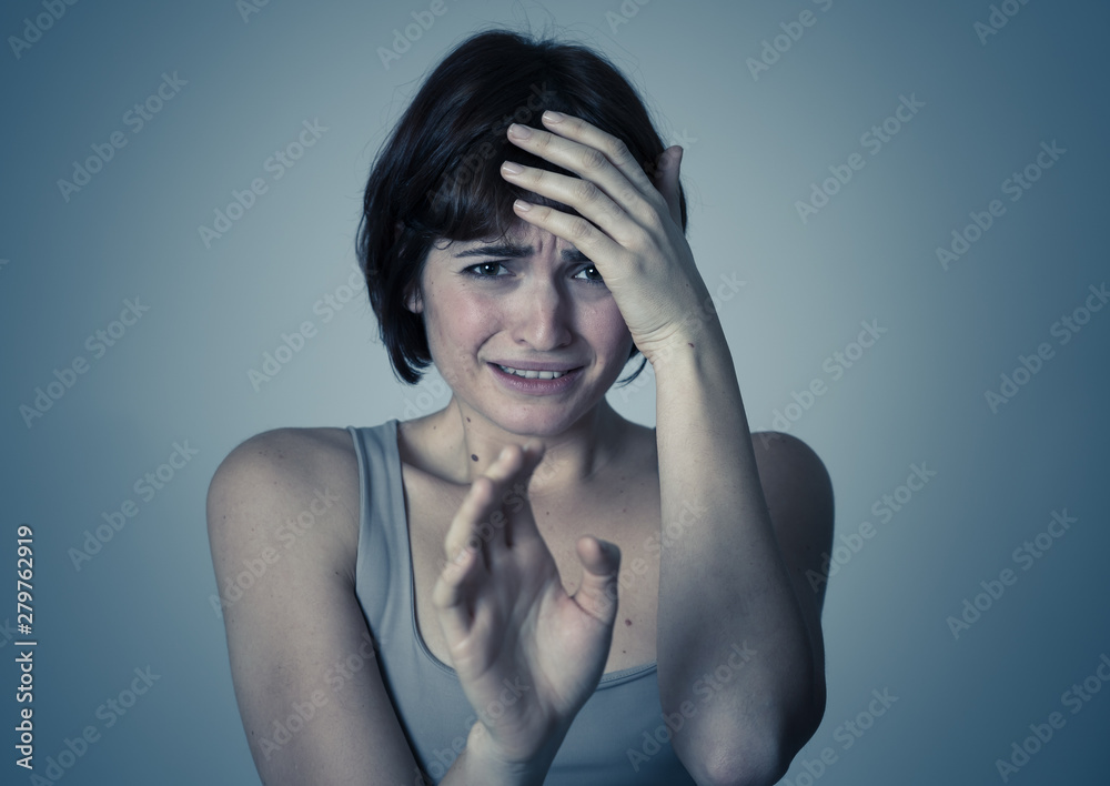 Fototapeta premium Portrait of a young attractive woman looking scared and shocked.Human expressions and emotions