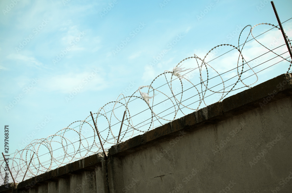 Protected area surrounded with wall and barber wire. Barbed wire used to prevent illegal entry. Protected area surrounded with wall and barber wire. Barbed wire used to prevent illegal entry.