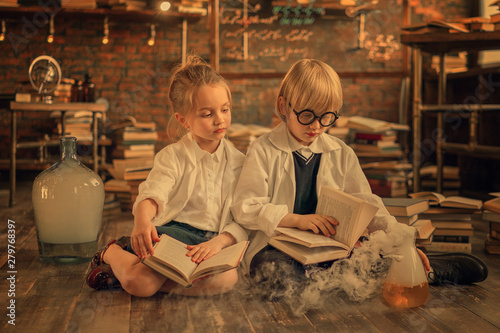 preschooler researchers reading books of chemistry in the lab