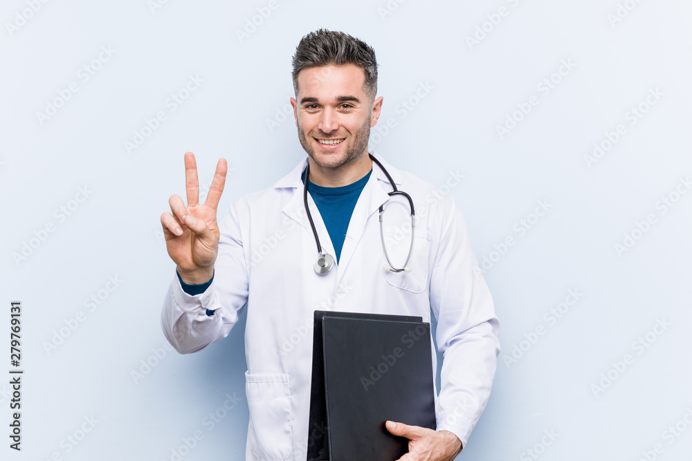 Caucasian doctor man holding a folder showing number two with fingers. Caucasian doctor man holding a folder showing number two with fingers.
