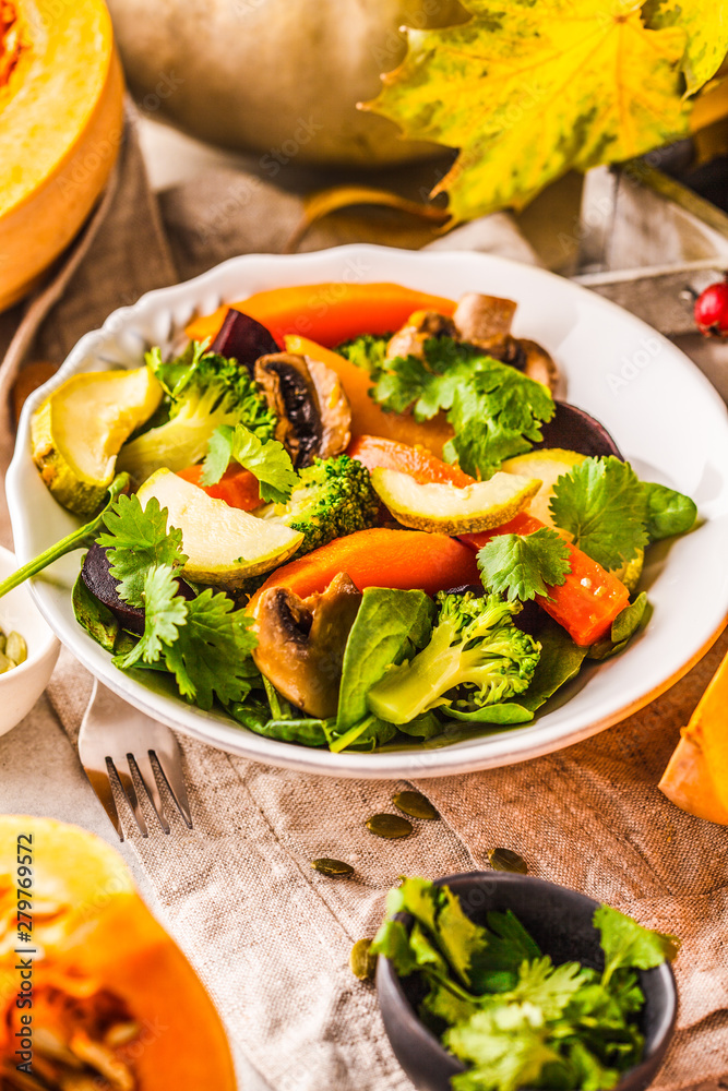 Autumn salad with baked pumpkin, beet, zucchini and carrots. Healthy vegan food concept. Autumn salad with baked pumpkin, beet, zucchini and carrots. Healthy vegan food concept.