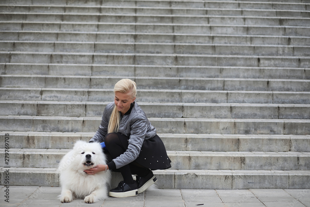 Lovely girl on a walk with a beautiful dog Lovely girl on a walk with a beautiful dog