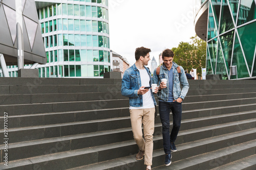 Two smiling young men friends dressed casually photo