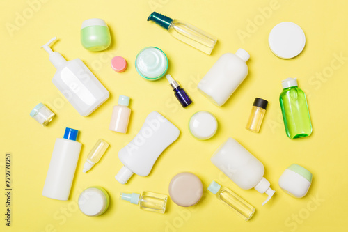 Group of plastic bodycare bottle Flat lay composition with cosmetic products on yellow background empty space for you design. Set of White Cosmetic containers, top view with copy space