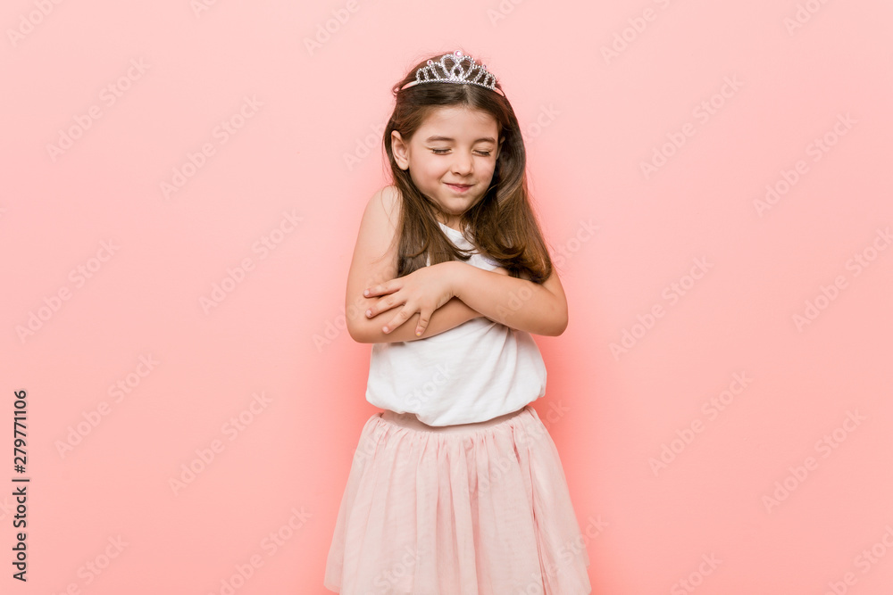 Little girl wearing a princess look hugs, smiling carefree and happy. Little girl wearing a princess look hugs, smiling carefree and happy.
