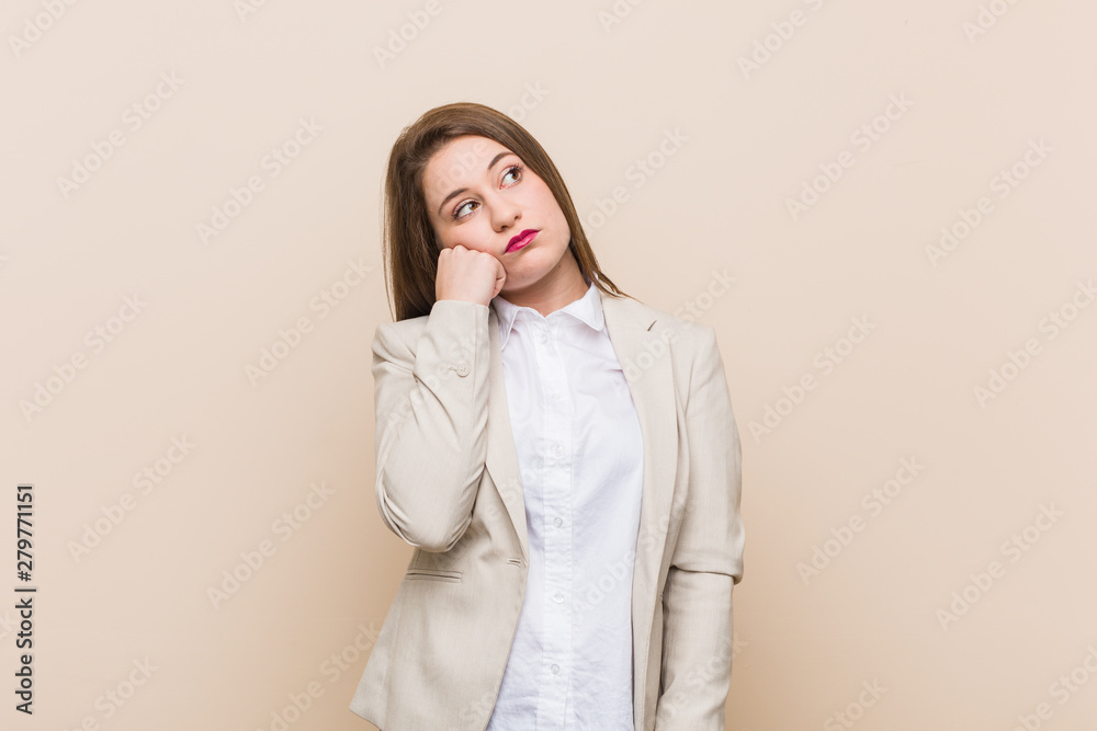 Young business woman who feels sad and pensive, looking at copy space. Young business woman who feels sad and pensive, looking at copy space.