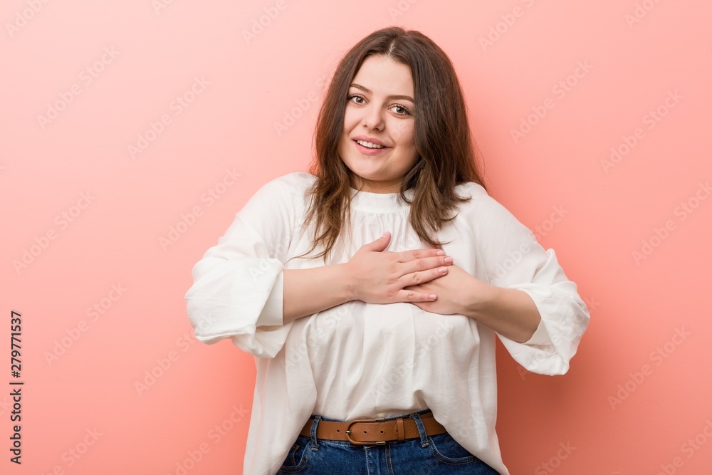 Young caucasian curvy woman standing against pink background Young caucasian curvy woman standing against pink background