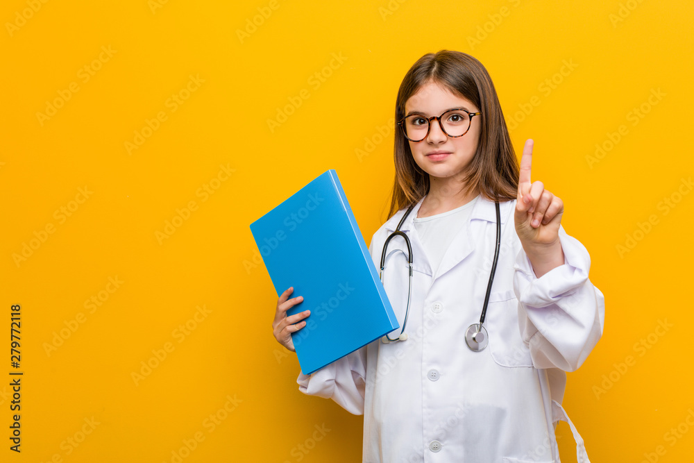 Little caucasian girl wearing a doctor costume Little caucasian girl wearing a doctor costume