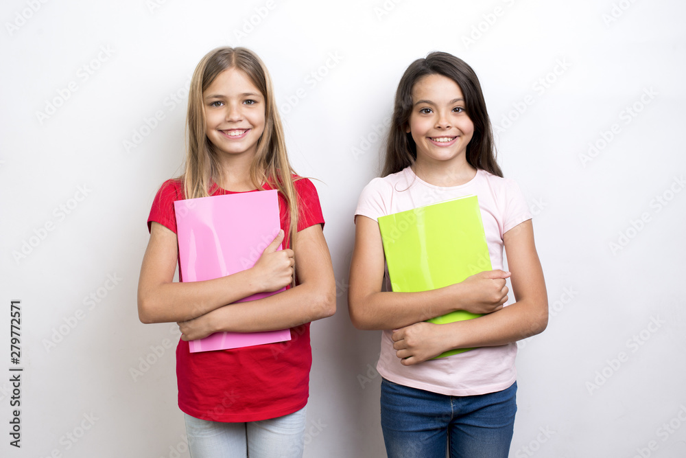 Cheerful multiethnic schoolgirls with workbooks Cheerful multiethnic schoolgirls with workbooks