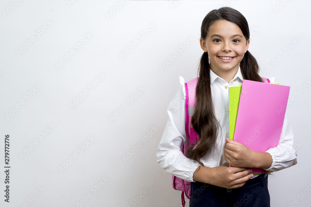 Excited Hispanic schoolgirl carrying copybooks Excited Hispanic schoolgirl carrying copybooks
