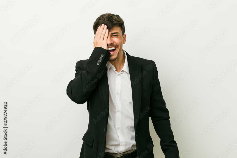 Young business hispanic man having fun covering half of face with palm. Young business hispanic man having fun covering half of face with palm.