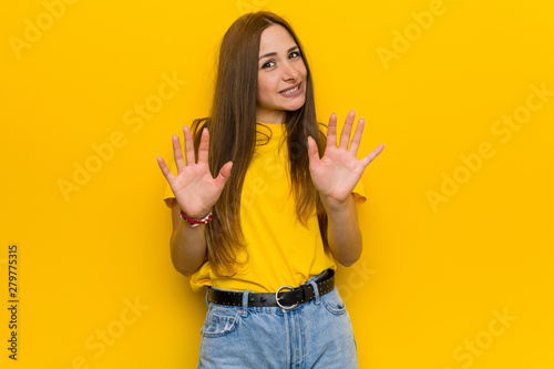 Young ginger redhead woman rejecting someone showing a gesture of disgust.