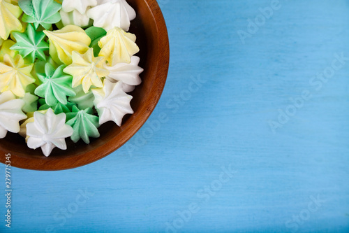 Meringue in a bowl on a blue  wooden background,
