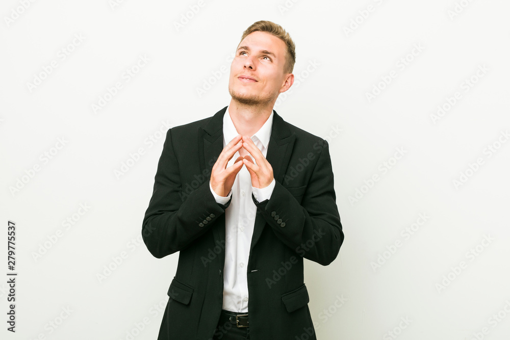 Young caucasian business man making up plan in mind, setting up an idea. Young caucasian business man making up plan in mind, setting up an idea.