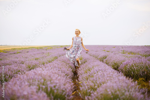 PHoto of handsome young woman, having fun in a lavender field