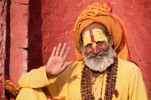 Sadhu man with traditional painted face in Pashupatinath Temple of Kathmandu, Nepal.Sadhu man refer to holy person.Nepal text in photo refer to prayer word om mani padme hum photo