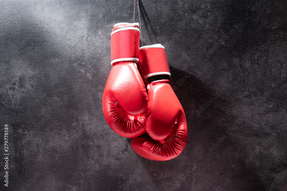 Pair of red boxing gloves hanging