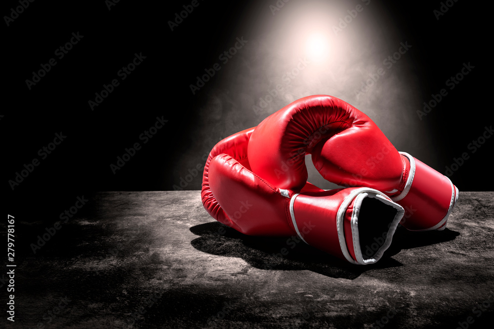 Pair of red boxing gloves under the light