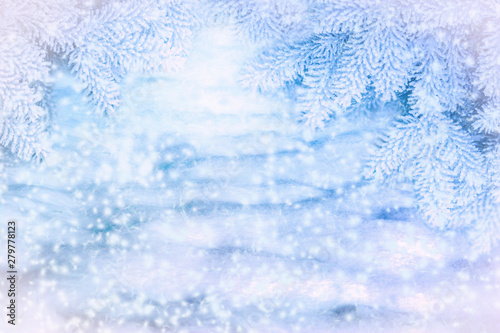 Winter scenic background. Christmas snow landscape with snowdrifts and spruce branches covered with snow in the frost. Falling snow on nature outdoors close-up