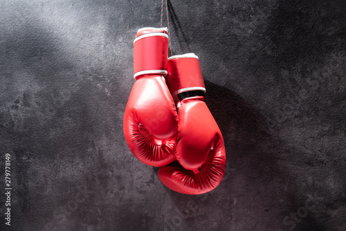 Pair of red boxing gloves hanging
