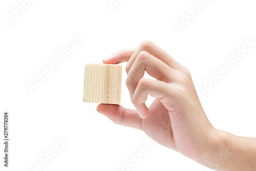 Hand holding wooden block toy