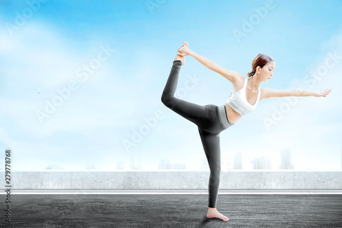 Asian healthy woman practicing yoga on the rooftop