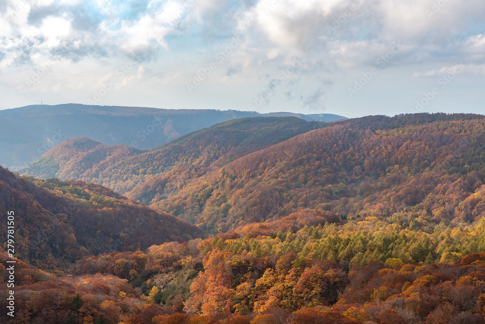 Autumn foliage scenery view, beautiful landscapes. Fall is full of magnificent colours. Entire mountain and valley is bathed in different hues of red, orange and golden colors background Autumn foliage scenery view, beautiful landscapes. Fall is full of magnificent colours. Entire mountain and valley is bathed in different hues of red, orange and golden colors background