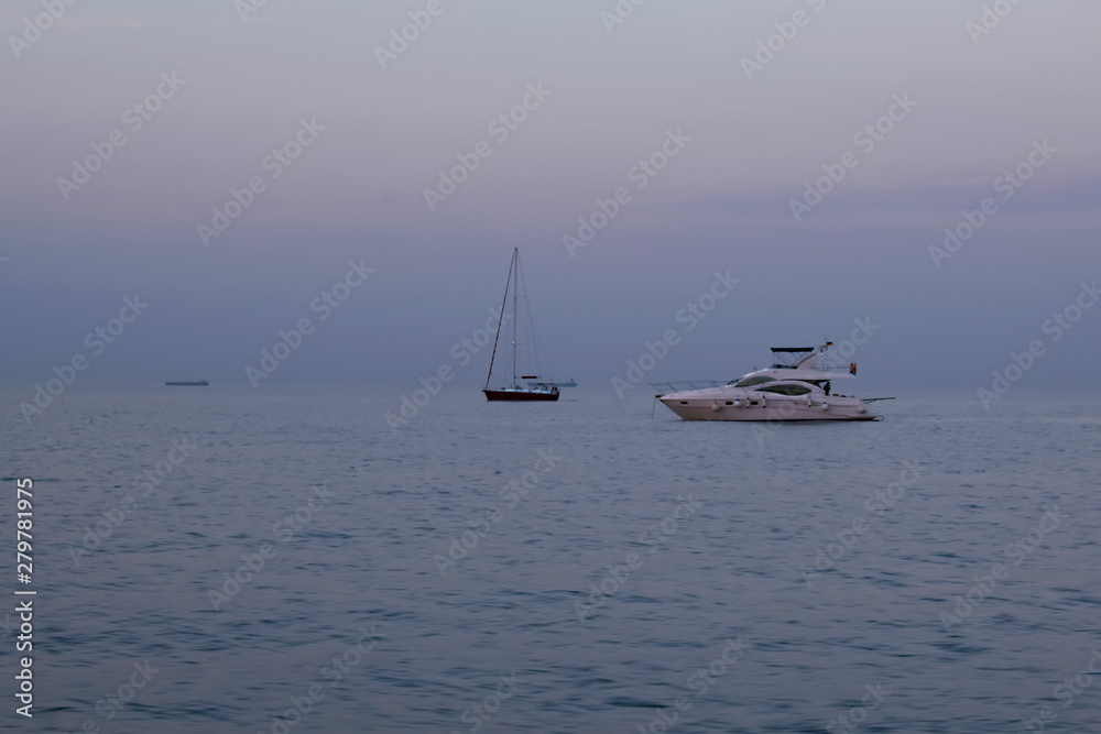 Boat in the blue sea, yacht in evening sea after sunset