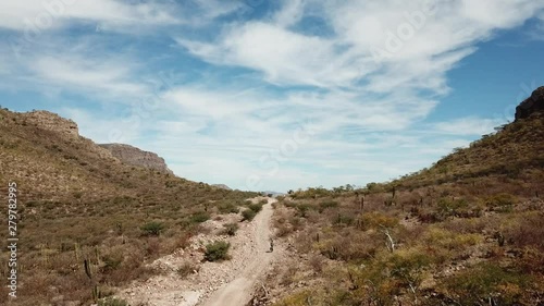 bicycle riding a canyon towards the sea in baja california
