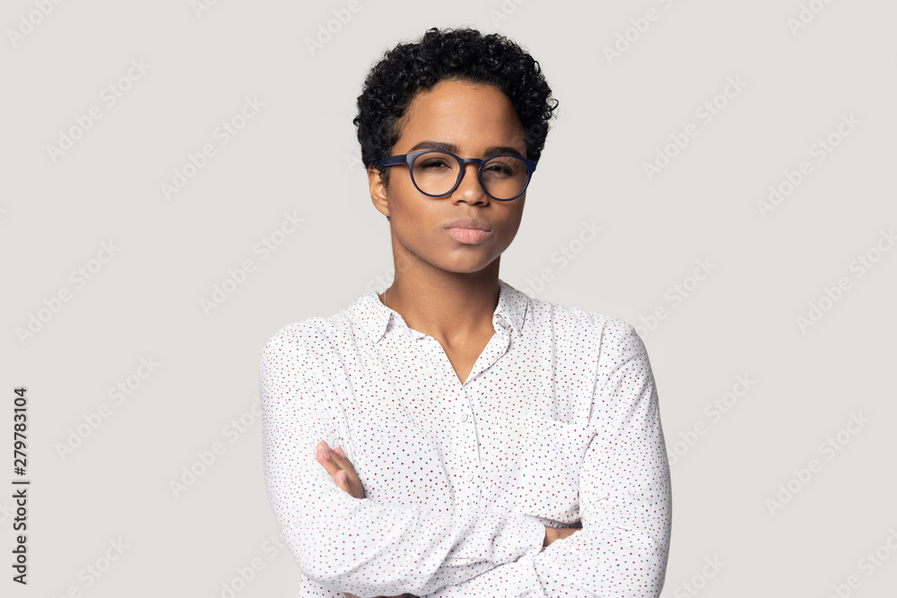 Doubtful biracial woman with arms crossed look at camera Doubtful biracial woman with arms crossed look at camera