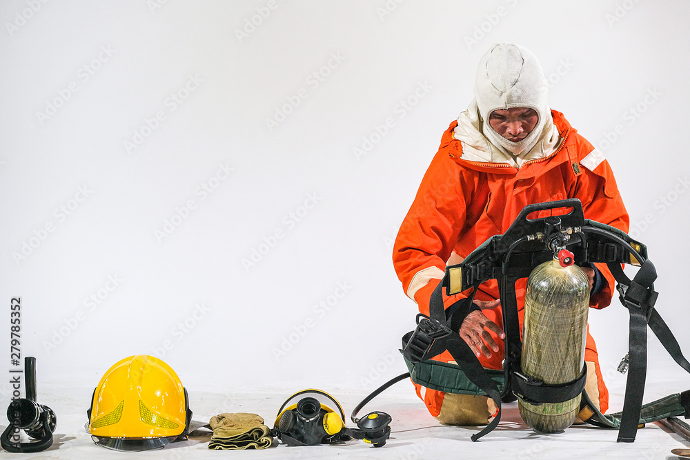 Fototapeta premium Firefighter demonstrates wearing uniforms, helmets and various equipment to prepare firefighters on a white background.